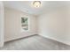 Bedroom with carpet and natural light through a window overlooking the front yard at 1021 Liberty Springs Dr, Woodstock, GA 30188