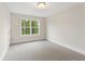 Neutral bedroom features plush carpet, a window offering plenty of natural light at 1021 Liberty Springs Dr, Woodstock, GA 30188