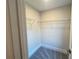Walk-in closet offers ample storage with wire shelving and plush gray carpet at 1021 Liberty Springs Dr, Woodstock, GA 30188