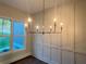 This dining room features a modern chandelier and decorative wall trim at 1021 Liberty Springs Dr, Woodstock, GA 30188