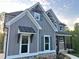 Charming two-story home with gray siding, white trim, and stone accents at 1021 Liberty Springs Dr, Woodstock, GA 30188