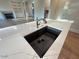 Modern kitchen island featuring a stainless steel faucet and black sink at 1021 Liberty Springs Dr, Woodstock, GA 30188