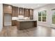 Well-lit kitchen featuring stainless steel appliances, a large island, and hardwood floors at 1021 Liberty Springs Dr, Woodstock, GA 30188