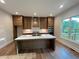 New kitchen with stainless steel appliances, large island, and wood flooring at 1021 Liberty Springs Dr, Woodstock, GA 30188