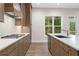 Gourmet kitchen with stainless appliances, white countertops, and wood cabinets at 1021 Liberty Springs Dr, Woodstock, GA 30188