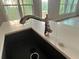 Modern kitchen featuring a stainless steel faucet, white countertop, and large windows with scenic views at 1021 Liberty Springs Dr, Woodstock, GA 30188