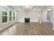 Spacious living room featuring hardwood floors, large windows, and a cozy fireplace at 1021 Liberty Springs Dr, Woodstock, GA 30188