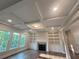 Bright living room featuring custom built-in bookshelves, a fireplace, and large windows with natural light at 1021 Liberty Springs Dr, Woodstock, GA 30188