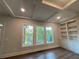 Living room with expansive windows offering scenic outdoor views and custom built-in shelves at 1021 Liberty Springs Dr, Woodstock, GA 30188