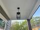 Covered front porch with black lantern and white trim at 1021 Liberty Springs Dr, Woodstock, GA 30188
