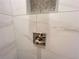 Chrome shower handle with marble-style wall tiles and shower niche at 1021 Liberty Springs Dr, Woodstock, GA 30188