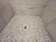Shower floor with pebble style tiles and drain at 1021 Liberty Springs Dr, Woodstock, GA 30188