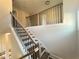 Staircase with hardwood steps, dark metal railings, and white risers at 1021 Liberty Springs Dr, Woodstock, GA 30188