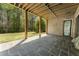 Covered back porch with slate flooring and wooden ceiling, offering a relaxing outdoor space at 117 Owens Mill Pl, Canton, GA 30115