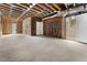 Unfinished basement featuring exposed framing, concrete flooring, utilities, and a staircase to upper level at 117 Owens Mill Pl, Canton, GA 30115