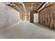 Large unfinished basement with visible framework, exposed ceiling, concrete floor, and a rear entrance at 117 Owens Mill Pl, Canton, GA 30115