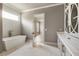 Elegant bathroom featuring a freestanding tub and modern vanity with decorative cabinetry at 117 Owens Mill Pl, Canton, GA 30115