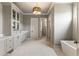 Elegant bathroom featuring double vanity, freestanding tub, and decorative chandelier lighting at 117 Owens Mill Pl, Canton, GA 30115