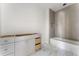Bright bathroom with neutral tiled shower/backsplash and white marble-look floor at 117 Owens Mill Pl, Canton, GA 30115