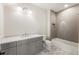 Bathroom featuring gray cabinets, marble counters, and shower-tub combo with decorative tiling at 117 Owens Mill Pl, Canton, GA 30115