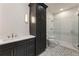 Modern bathroom features granite countertop, dark cabinets, tile flooring and glass enclosed shower at 117 Owens Mill Pl, Canton, GA 30115