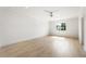 Large, bright bedroom features two windows and hardwood floors, with a ceiling fan at 117 Owens Mill Pl, Canton, GA 30115