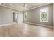 Bright bedroom with hardwood floors and windows overlooking trees and lush greenery at 117 Owens Mill Pl, Canton, GA 30115