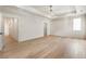 Spacious and well lit primary bedroom featuring hard wood flooring and tray ceiling at 117 Owens Mill Pl, Canton, GA 30115