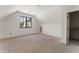 Spacious bonus room featuring neutral paint, large window, and convenient closet storage at 117 Owens Mill Pl, Canton, GA 30115