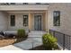 Charming home featuring a brick facade, welcoming front porch with natural wood posts, and meticulous landscaping at 117 Owens Mill Pl, Canton, GA 30115
