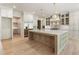 Spacious kitchen with large island, stainless appliances, custom cabinets, and modern pendant lighting at 117 Owens Mill Pl, Canton, GA 30115
