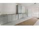 Unfinished kitchen with white marble floors and custom cabinets with plenty of storage space at 117 Owens Mill Pl, Canton, GA 30115
