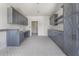 Spacious kitchen with gray cabinets, stainless fixtures, and ample counter space at 117 Owens Mill Pl, Canton, GA 30115