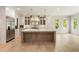 Spacious kitchen with large island, stainless appliances, custom cabinets, and modern pendant lighting at 117 Owens Mill Pl, Canton, GA 30115