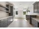 Laundry room with gray cabinets, stylish tile floor, and natural light at 117 Owens Mill Pl, Canton, GA 30115
