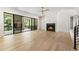 Modern living room with hardwood floors, a fireplace, and large sliding doors to the deck at 117 Owens Mill Pl, Canton, GA 30115