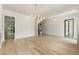 Open-concept living room with bright natural light, sleek hardwood floors, and modern lighting at 117 Owens Mill Pl, Canton, GA 30115
