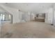 Expansive living room flows into kitchen with unfinished flooring and neutral color palette at 117 Owens Mill Pl, Canton, GA 30115