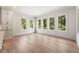 Bright living room with hardwood floors and large windows overlooking lush greenery at 117 Owens Mill Pl, Canton, GA 30115