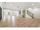 Spacious living room with hardwood floors, beverage center, and modern staircase at 117 Owens Mill Pl, Canton, GA 30115