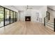 Spacious living room with hardwood floors, a modern fireplace, and access to the staircase at 117 Owens Mill Pl, Canton, GA 30115