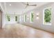 Spacious living room with light wood floors, white walls, recessed lighting and multiple windows providing natural light at 117 Owens Mill Pl, Canton, GA 30115