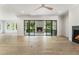 Open living space featuring hardwood floors, a fireplace, and large sliding glass doors to the back deck at 117 Owens Mill Pl, Canton, GA 30115