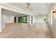 Spacious living room features light wood floors, white walls and black framed doors leading to outdoor living space at 117 Owens Mill Pl, Canton, GA 30115