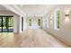 Large living room boasts light wood floors, white walls and multiple windows showcasing outdoor views and lots of natural light at 117 Owens Mill Pl, Canton, GA 30115