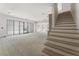 Open living area with staircase, and large windows bringing in plenty of natural light at 117 Owens Mill Pl, Canton, GA 30115