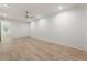 Bright living room with light wood floors, white walls and ceiling fan at 117 Owens Mill Pl, Canton, GA 30115