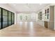 Open-concept living room with hardwood floors, modern beverage center, and access to outdoor patio at 117 Owens Mill Pl, Canton, GA 30115