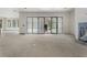 Unfinished living area featuring a set of sliding glass doors and view to the kitchen and fireplace at 117 Owens Mill Pl, Canton, GA 30115