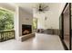 Covered outdoor patio with brick fireplace, ceiling fan, and bar area at 117 Owens Mill Pl, Canton, GA 30115